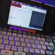 A Steam Deck sits in front of a computer in desktop mode.